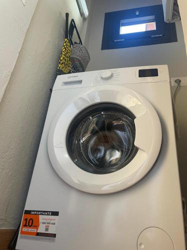 a washing machine is sitting in a room at Orta Lake Apartments II in Omegna