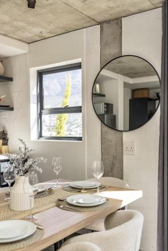 a dining room with a table and a mirror at Central Apartment in Cape Town in Cape Town