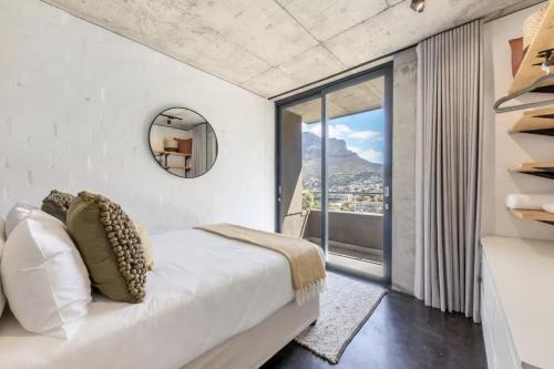 a bedroom with a bed and a large window at Central Apartment in Cape Town in Cape Town