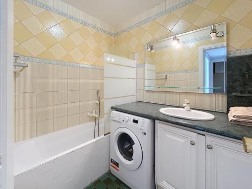 une salle de bain avec une machine à laver et un lavabo dans l'établissement La Salangane, à Cannes