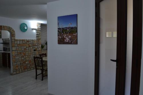 a door leading into a living room with a picture on the wall at TAVERNETTA DEL BORGO in Specchia