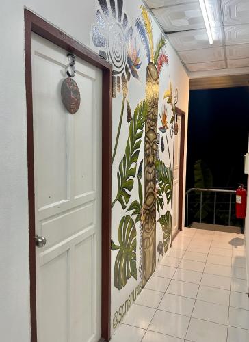 a door in a hallway with a mural of a giraffe at Tiki Tribe Bar & Hostel in Koh Tao