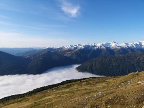 a view from the top of a mountain with clouds at Sonnseitn Appartments in Sankt Martin