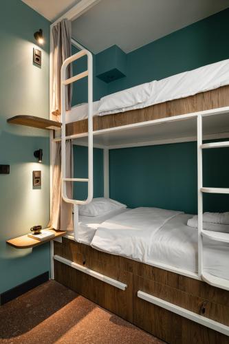 a room with two bunk beds with a ladder at Zeus is Loose Hostel in Thessaloniki
