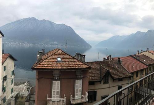 a group of buildings with a view of the water and mountains at The Family Houses - Apartments with Balcony and Lake View in Colonno