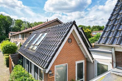 a house with solar panels on the roof at Wellness apartment Apeldoorn with Sauna and Jacuzzi in Apeldoorn