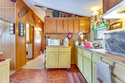 a kitchen with a sink and a microwave at Hike, Ski and Unwind Cabin with Deck in Chester! in Chester