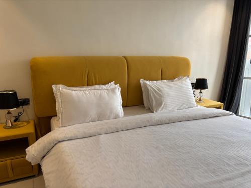 a bed with white sheets and pillows in a room at Baga Beach Sea Salacia in Goa