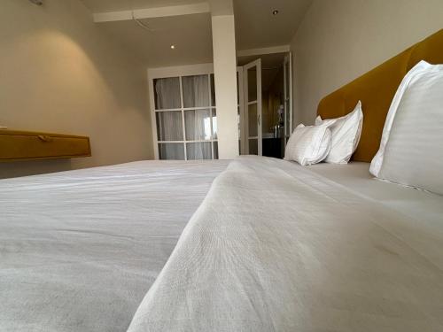 a large white bed in a room with a window at Baga Beach Sea Salacia in Goa