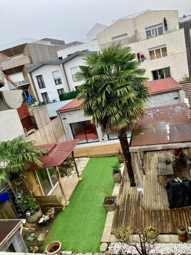 an aerial view of a yard with a palm tree at PARIS-DISNEY Homestay in Noisy-le-Grand