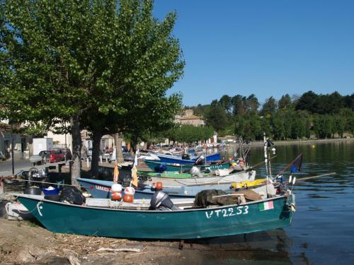 a group of boats are docked in the water at Locanda Da Otello in Marta