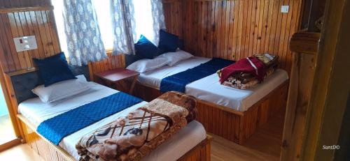 a bedroom with two beds in a boat at Kolakham Nature View Home Stay in Lava