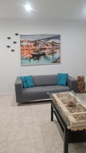a living room with a couch and a table at Maligueira Apartment in Leiria