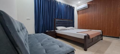 a bedroom with a bed and a chair in it at 430 Islamabad in Islamabad