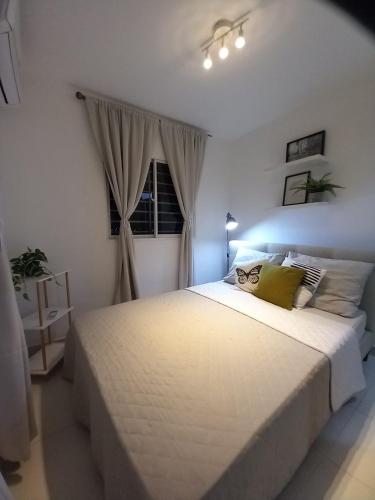 a bedroom with a large white bed and a window at Tia best place in Mata los Indios