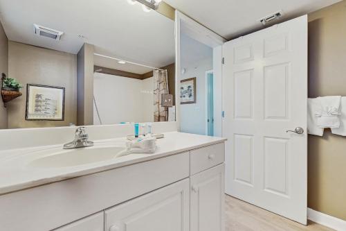 a bathroom with a white sink and a mirror at Pelican Isle 418 in Fort Walton Beach