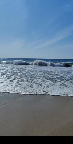 a beach with waves crashing on the shore at Serendip Villa Holiday HomeTalalla Sri Lanka in Matara