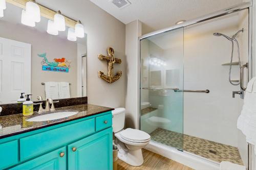a bathroom with a toilet and a glass shower at Madeira Bay Resort 509 in St Pete Beach