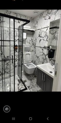 a black and white bathroom with a toilet and a sink at LOTUS OTEL in Konya