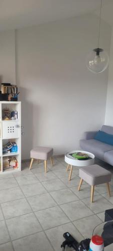 a living room with a couch and a table at Appartement vue mer in La Bernerie-en-Retz