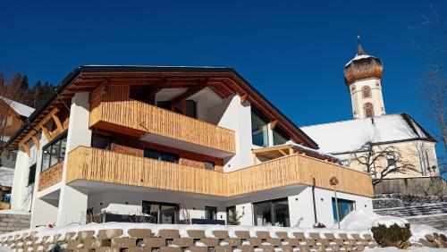 a building with a clock tower in the background at 12er Residence in Bürserberg