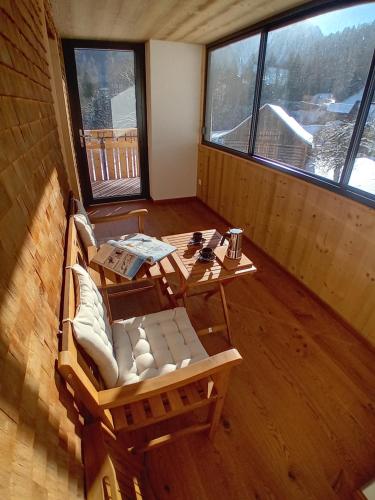 a room with a table and a couch and a table and chairs at 12er Residence in Bürserberg