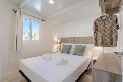 a white bedroom with a white bed and a window at Costa del Sol Glamping Village in Fuengirola