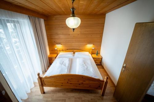a bedroom with a bed in a wooden room at Alpen Suite Apartment in San Vigilio Di Marebbe