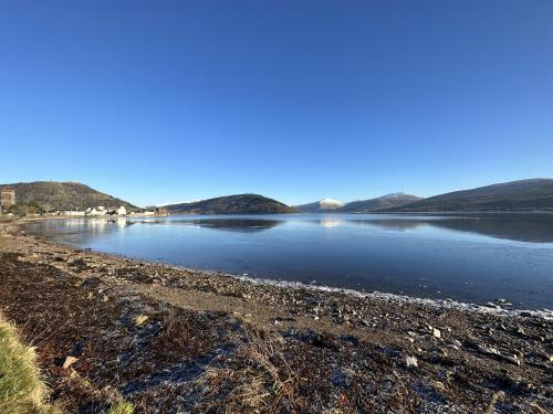 a large body of water with mountains in the background at Traditional Inveraray Cottage - Amazing Loch Views in Inveraray