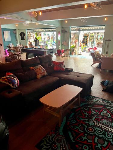 a living room with a couch and a table at Tiki Tribe Bar & Hostel in Koh Tao