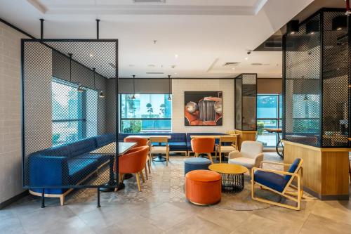 a room with chairs and tables and windows at Holiday Inn Express Greater Noida Knowledge Park by IHG in Greater Noida