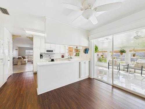 a kitchen and living room with a ceiling fan at Pet-Friendly 3BR Coastal Retreat Walk to Beach in Satellite Beach