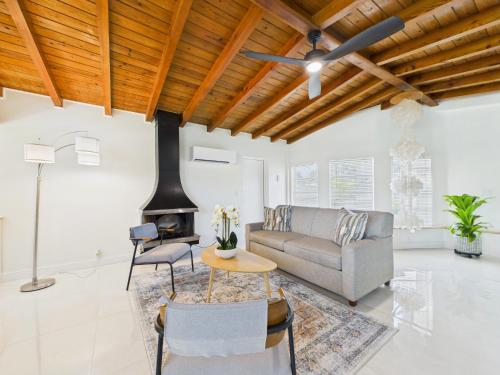 a living room with a couch and a fireplace at Pet-Friendly 3BR Coastal Retreat Walk to Beach in Satellite Beach