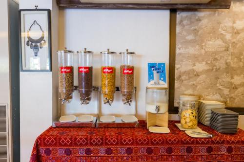 a table with a red table cloth with jars of food at Nak Nakara Hotel in Chiang Rai