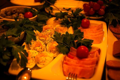 a plate of food on a table with food at Hotell Aqva Restaurang & Bar Ett Biosfärhotell med fokus på hållbarhet in Mariestad