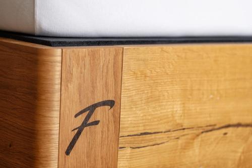 a wooden table with a x sign on it at Design-Chalet mit Teilseeblick, Pool, Spa & Restaurant in Lochau