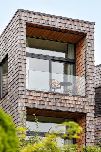 a window with a table and a chair in it at Design-Chalet mit Teilseeblick, Pool, Spa & Restaurant in Lochau