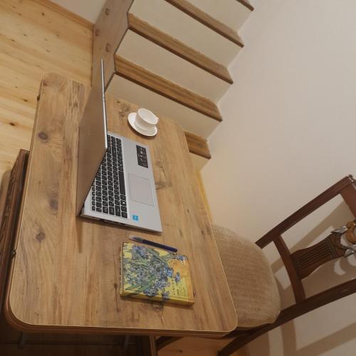 a wooden table with a laptop computer on it at Sweet Home in Tbilisi City