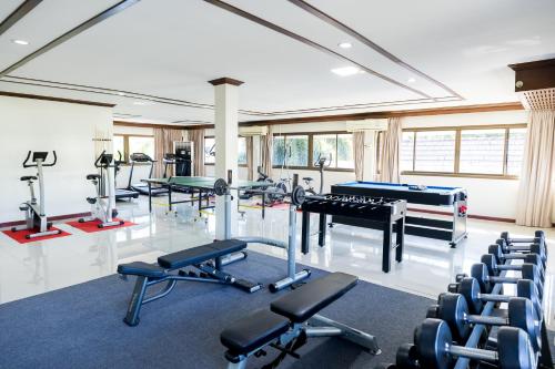 a gym with exercise equipment and a pool table at Nak Nakara Hotel in Chiang Rai