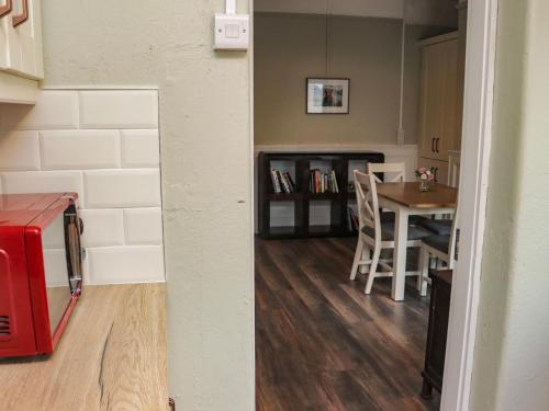 a room with a kitchen and a dining room with a table at Heatherbell House in Dún ar Aill