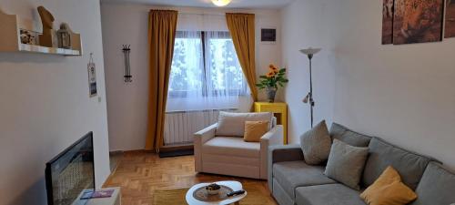 a living room with a couch and a chair at Zlatiborski Konaci in Zlatibor