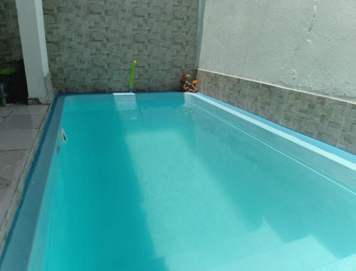 a swimming pool with blue water in a room at Pousada Recanto do Mar in Tutóia