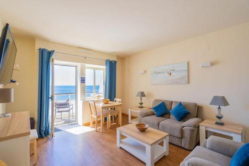 a living room with a couch and a table at Luz Beach Apartments in Luz