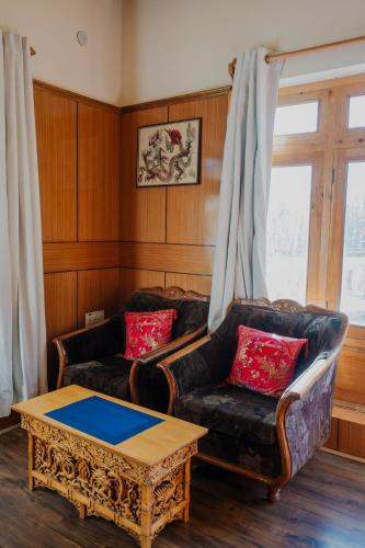a living room with two couches and a coffee table at The Destination Homestay in Leh