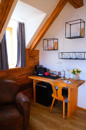 a room with a wooden desk in a attic at Gmundnerberghaus - ROOMS in Altmünster