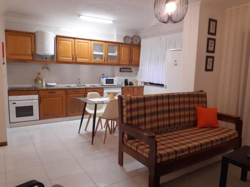 a kitchen with a couch and a table in it at Amorosa Beach Sun And Sea in Viana do Castelo