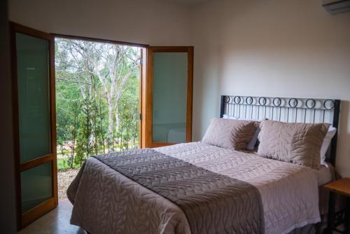 Ένα ή περισσότερα κρεβάτια σε δωμάτιο στο Hotel Fazenda São Silvano