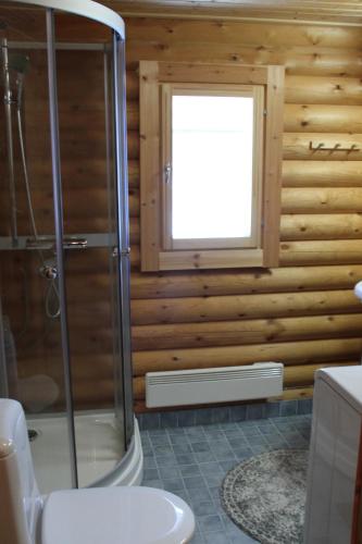 a bathroom with a shower and a window at Markkula in Koitila