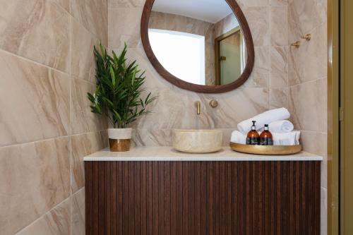 a bathroom with a sink and a mirror at Naiades Boutique Hotel - Adults Only in Elounda