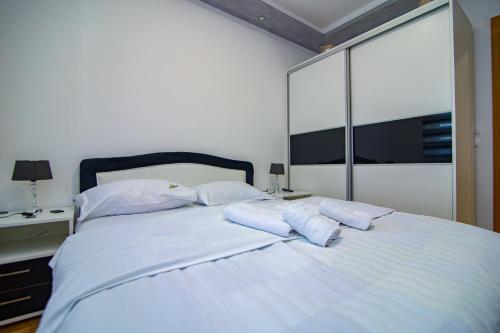 a large white bed with two pillows on it at Zlatiborski Konaci in Zlatibor